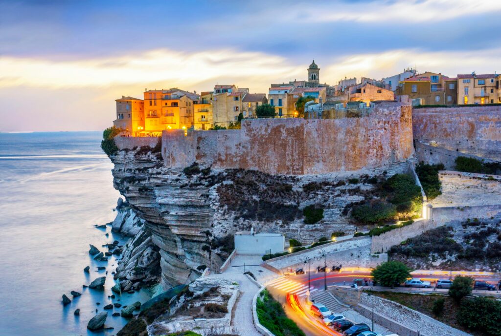 Corsica, France is one of the best places to visit in France for breathtaking views. Here, Bonafacio looms on a cliff over the Mediterranean Sea.