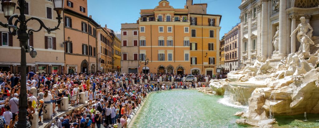 Peak season in Rome at the Trevi Fountain shows why you should book a trip to Italy early.
