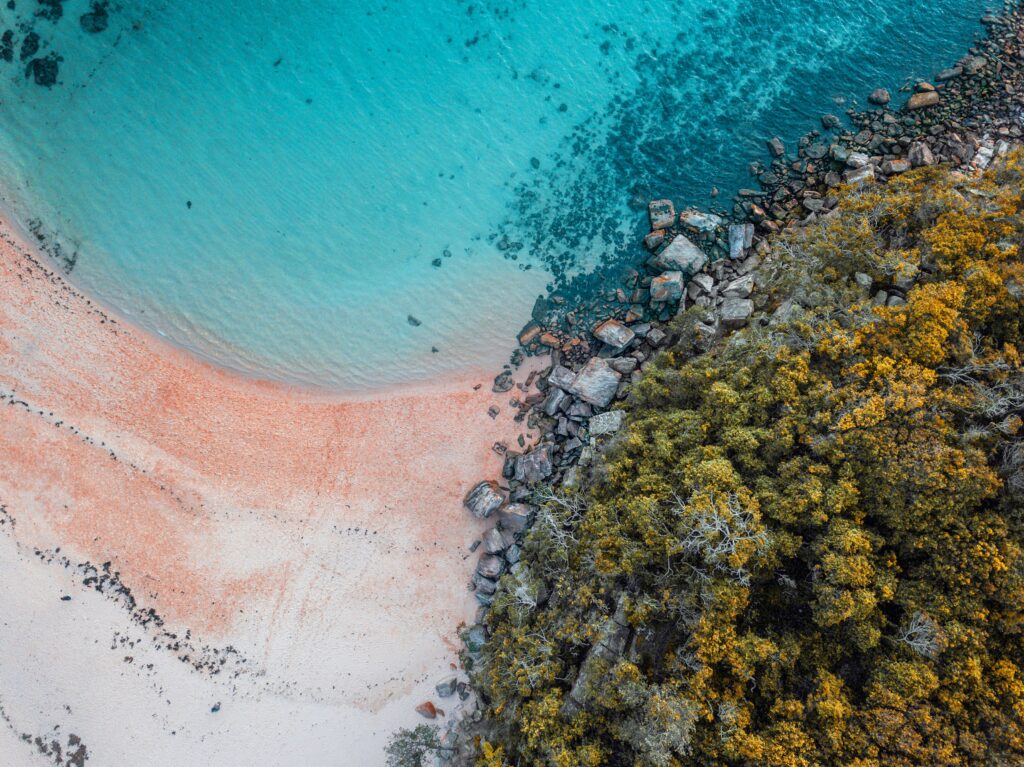 Aerial view of where coastline meets bushland, showing the scale that determines how many days you need in Australia