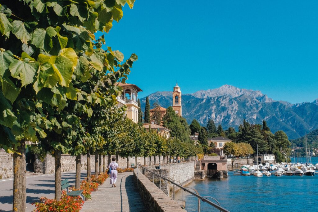 Lakeside walkway in Lake Como, Italy, a slow travel destination with mountains