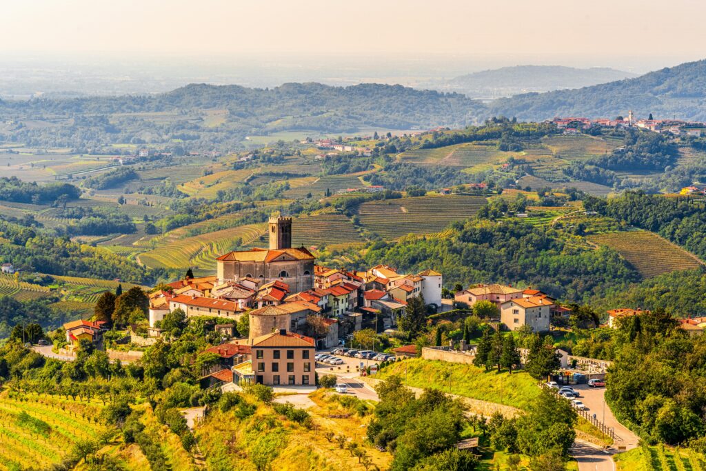 Rolling hills and hilltop village in Italy in spring, one of the best times to visit Italy for mild weather and fewer crowds